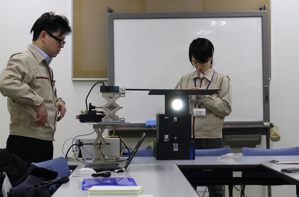 Higashi and Hata at work in the lab