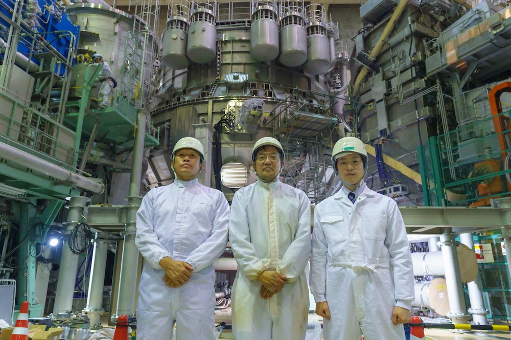 Mr. Shibama, Hanada, and Sagawa standing in front of JT-60SA