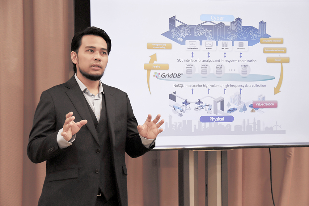 Angga Suherman from Toshiba’s Data Business Promotion Department explaining cyber‑physical systems and the changing role of databases.